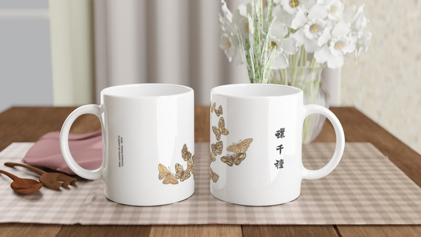 Illustration de papillons aux formes anguleuses – Kamisaka Sekka. Mug blanc illustré de papillons aux formes anguleuses et sombres, avec des touches de vert, de brun et de jaune, disposés en arc de cercle, et des inscriptions japonaises noires. Image d'illustration 2