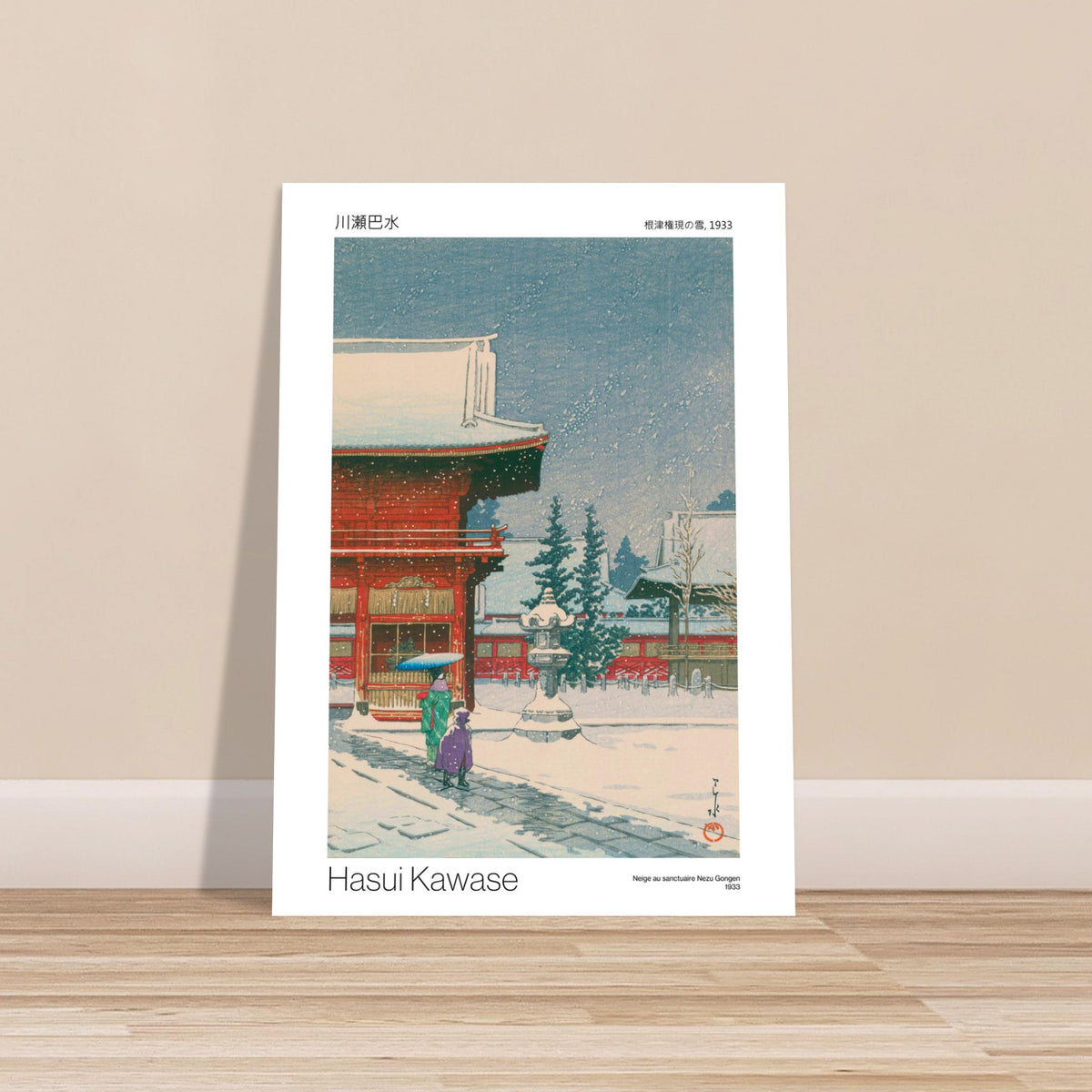 Hasui Kawase Druck: Schnee am Nezu-Gongen-Schrein. Szene eines japanischen Schreins im Schneefall, mit rot-weißen Gebäuden, Bäumen und zwei Personen, die einen Regenschirm halten.