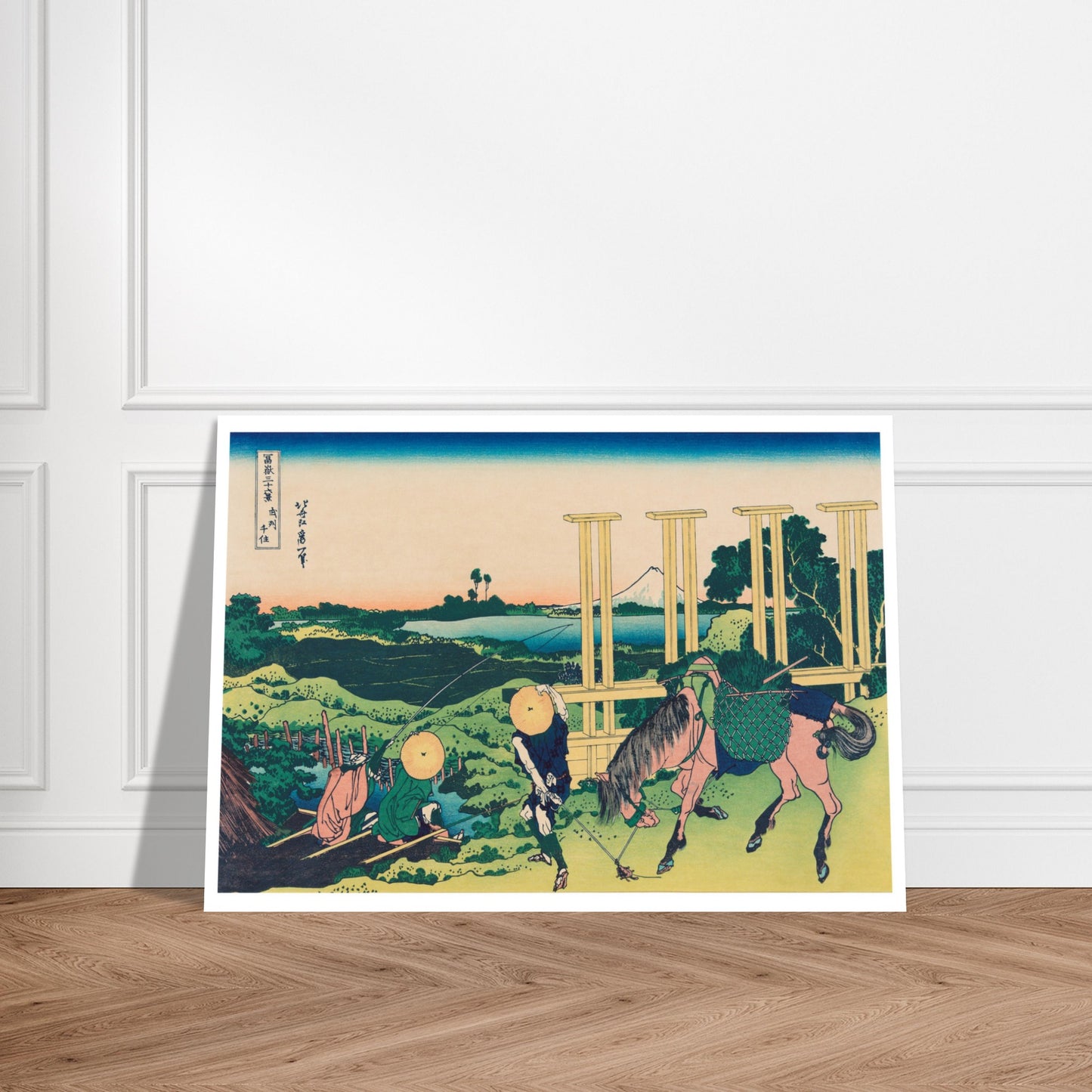 Estampe Senju dans la province de Musashi - Katsushika Hokusai. Estampe ukiyo-e représentant Senju dans la province de Musashi, avec une personne et un cheval portant des charges près d'une structure en bois, et le Mont Fuji au loin. Image d'illustration 7